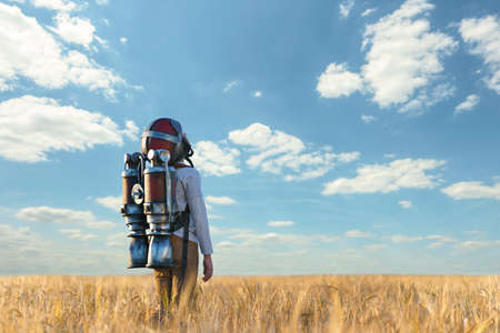 Boy with helmet in wheat fieldの写真素材