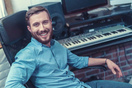 Smiling producer in recording studioの写真素材