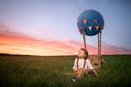 Dreaming boy with a balloon outdoorsの写真素材