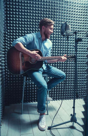 Singing man with a guitarの写真素材