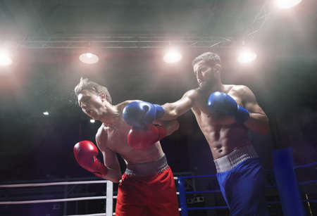 Active men in boxing ringの写真素材