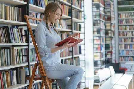 Smiling girl in a library