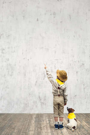 Little scout with dog in studioの写真素材