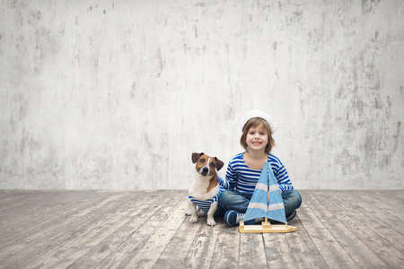 Little sailor with dog indoorsの写真素材