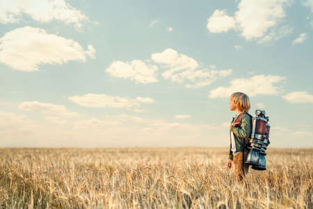 Little boy with a backpack outdoorsの写真素材