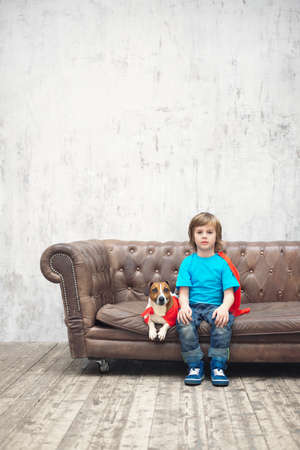Little boy with dog indoorsの写真素材
