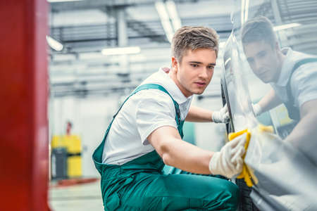 Young man with car in serviceの写真素材