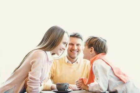 Smiling family in cafeの写真素材