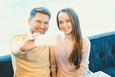 Smiling couple makes selfieの写真素材