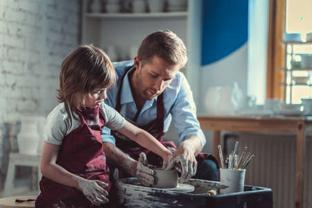 Teacher and pupil in potteryの写真素材