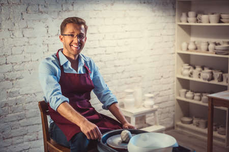 Smiling man at work indoorsの写真素材