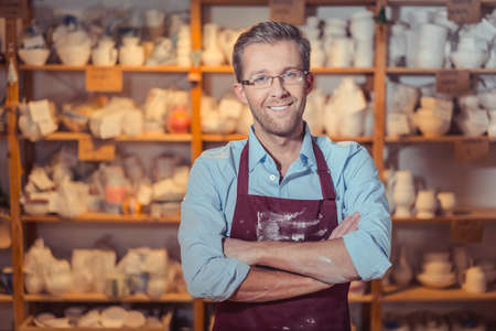 Smiling man in potteryの写真素材