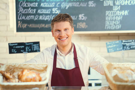 Smiling worker in bakeryの写真素材