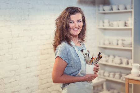 Smiling attractive painter in studioの写真素材