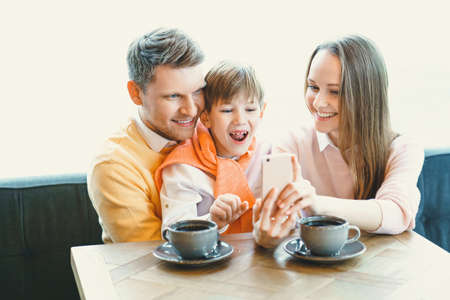 Smiling family in cafeの写真素材