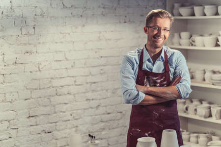 Smiling potter in studio