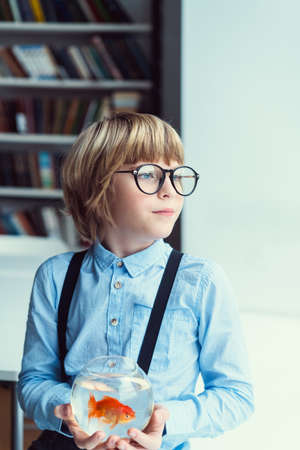 Little boy with goldfish indoors