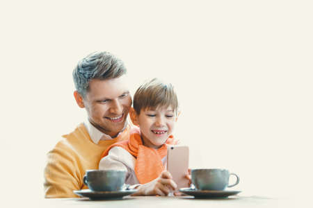 Young father with a child in cafeの写真素材
