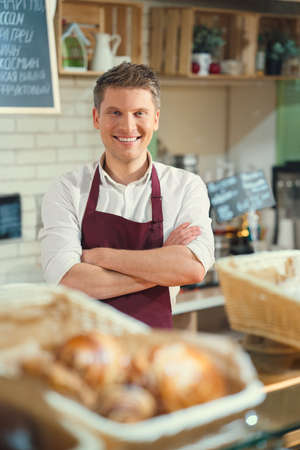 Smiling baker at the counterの写真素材