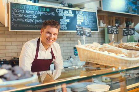 Smiling baker at the counterの写真素材