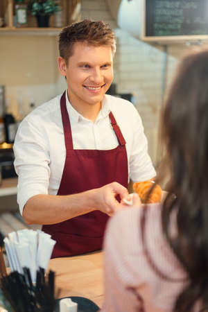 Smiling baker in cafeの写真素材