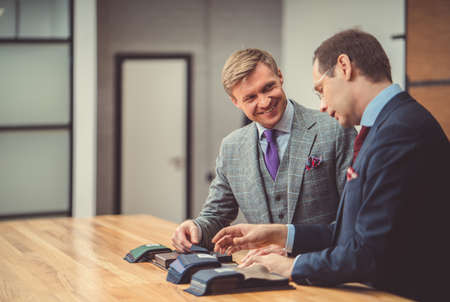 Smiling businessmen in atelierの写真素材