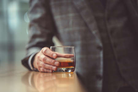 Man in suit with glass close-upの写真素材