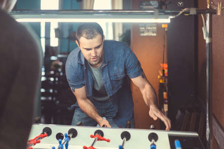 Young ?an playing table footballの写真素材