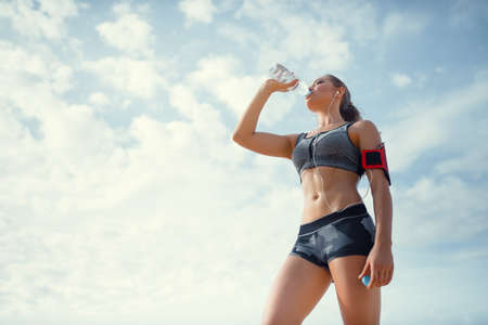 Drinking woman in uniform outdoorsの写真素材