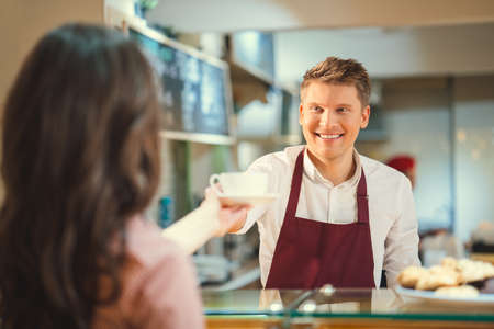 Young baker in a cafeの写真素材