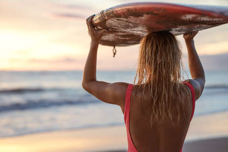 Attractive woman with surfboard outdoorsの写真素材