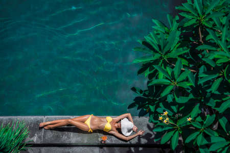 Young woman by the poolの写真素材