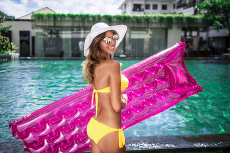 Smiling woman with air mattress