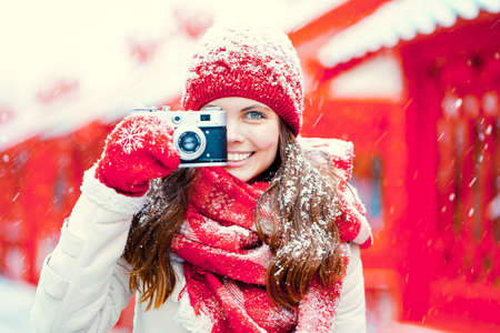 Young woman with a retro cameraの写真素材