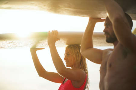 Happy couple with surfboards