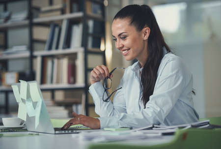 Smiling woman with laptop