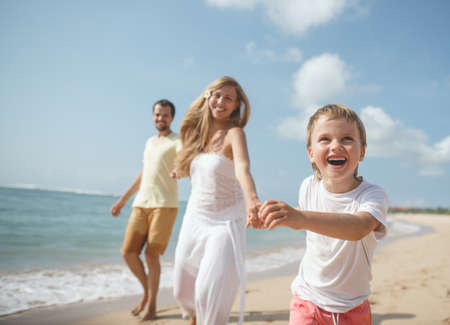 Happy family on the beachの写真素材