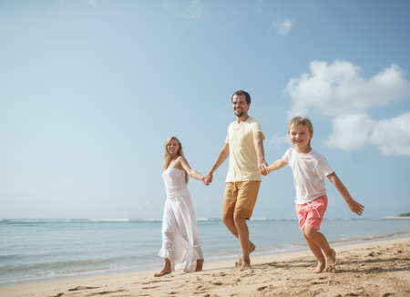 Happy family on the beachの写真素材