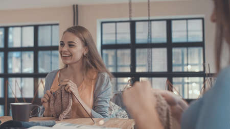 Happy young girl knitting in studioの写真素材