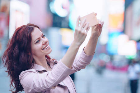 Attractive girl doing selfie in the city