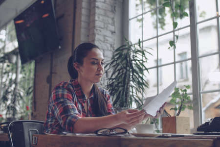 Young woman at work in cafeの写真素材