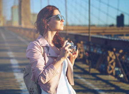 Smiling girl with a retro cameraの写真素材