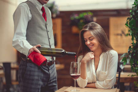 Smiling girl in restaurantの写真素材