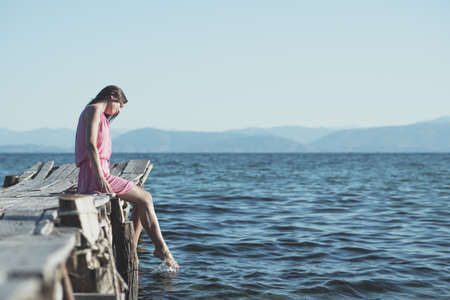 Attractive girl on a pierの写真素材