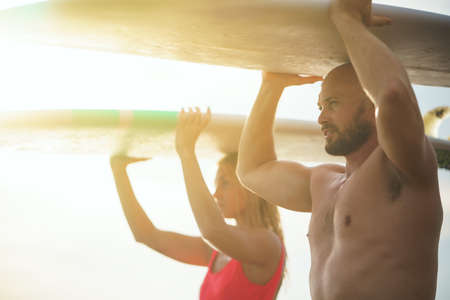 Young surfers in the sunlightの写真素材