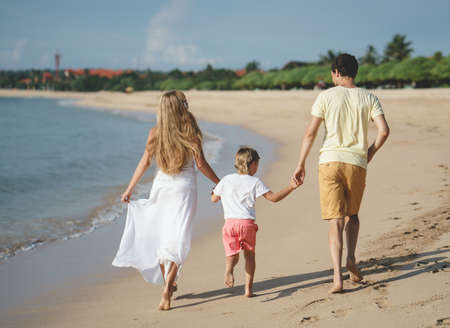 Young family on the beachの写真素材