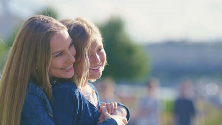 Smiling mother and daughter in the park