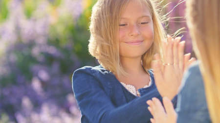 Happy mom and girl in the park