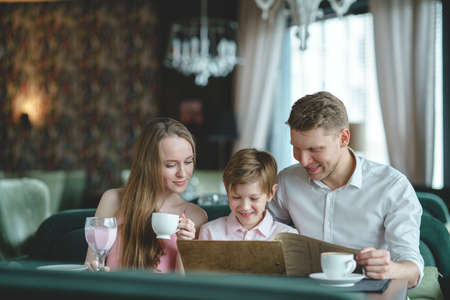 Young family with child in a restaurantの写真素材
