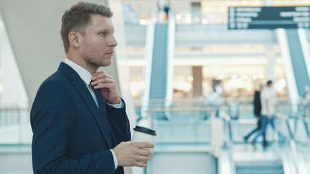 Young businessman with coffee in the storeの写真素材